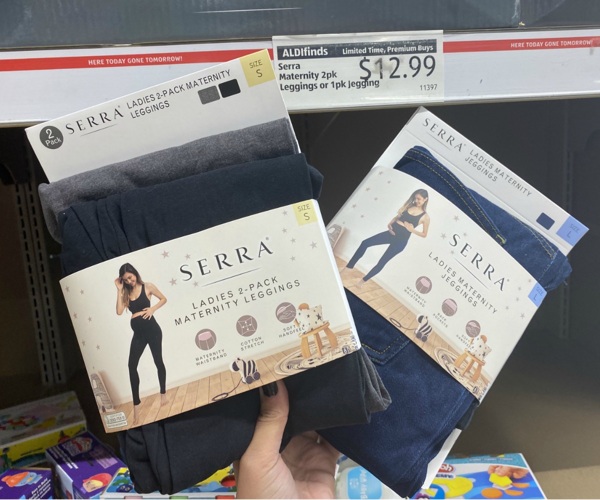 hand holding 2 wrapped packages of women's leggings