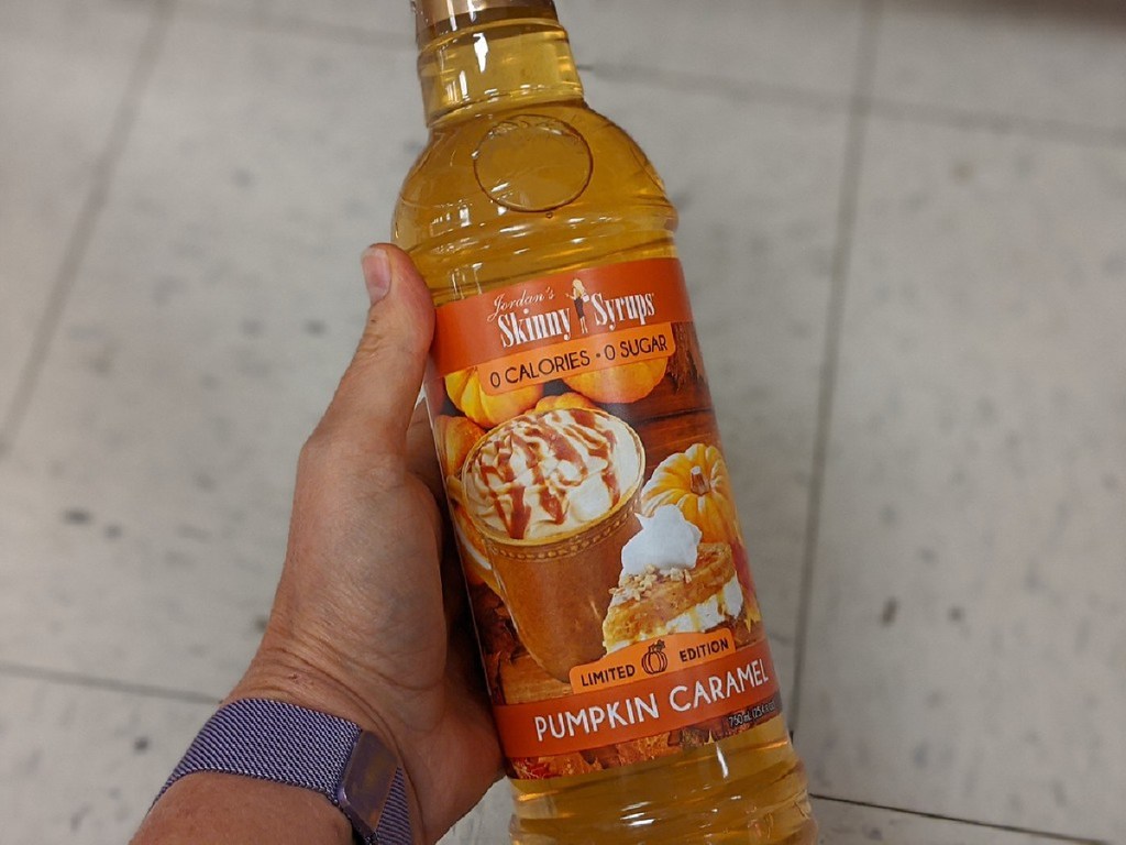hand holding large bottle of pumpkin caramel sugar free syrup