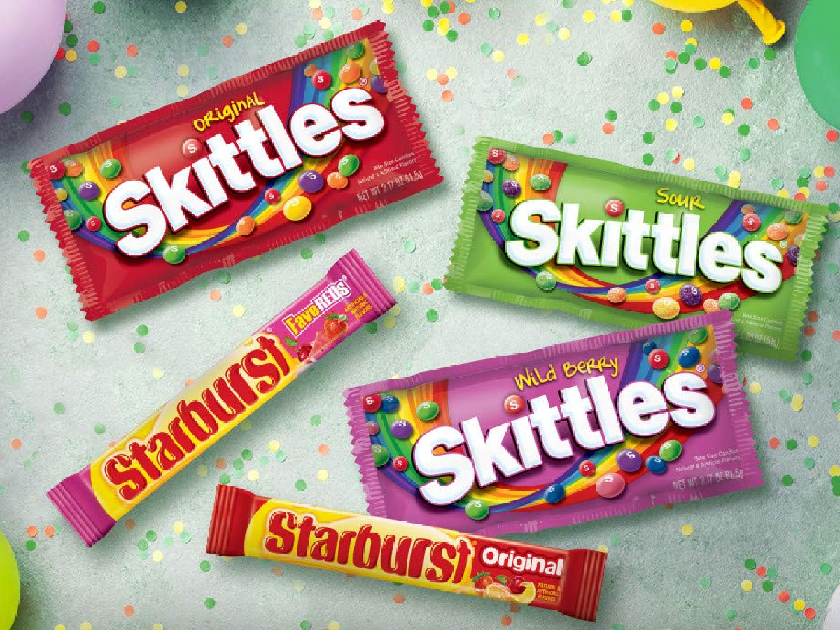 three different flavored Skittles bags and two different flavored Starburst packs