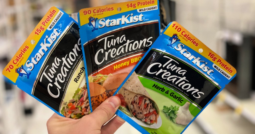 hand holding StarKist Tuna Creations in ranch, honey bbq, and her & garlic pouches