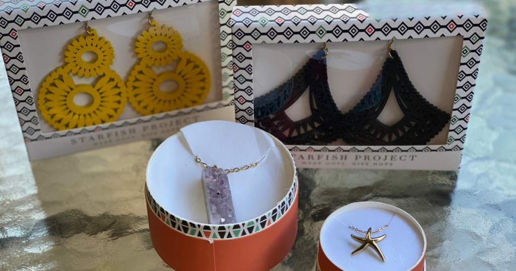 Starfish Project Jewelry sitting in boxes on a glass table