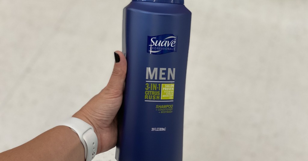 woman's hand holding a large bottle of suave men's body wash