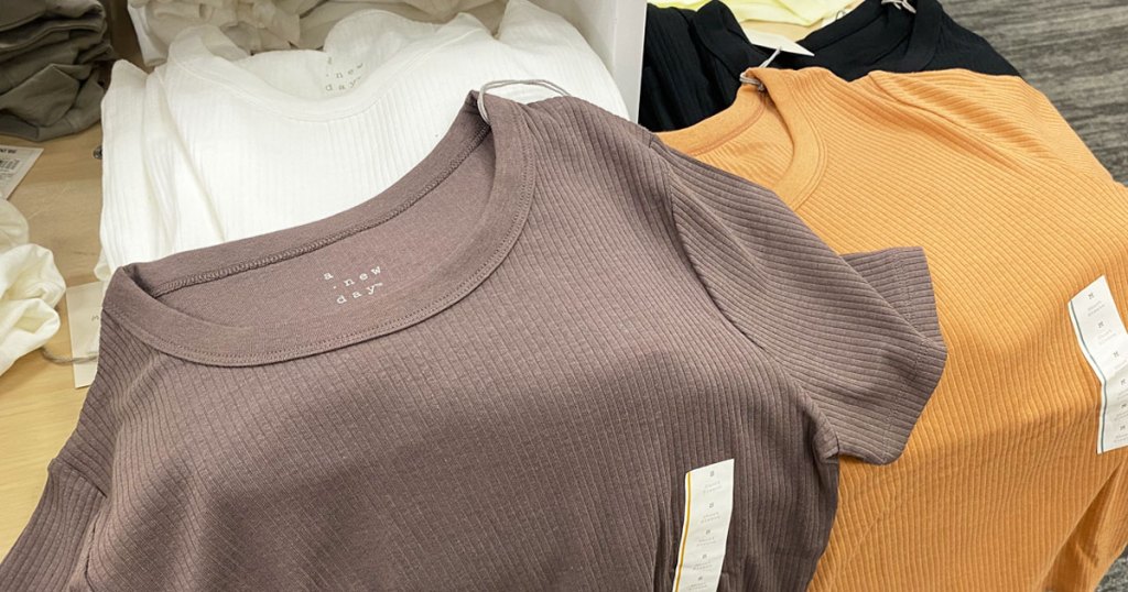 women's ribbed t-shirts in mauve and yellow colors on a target display table