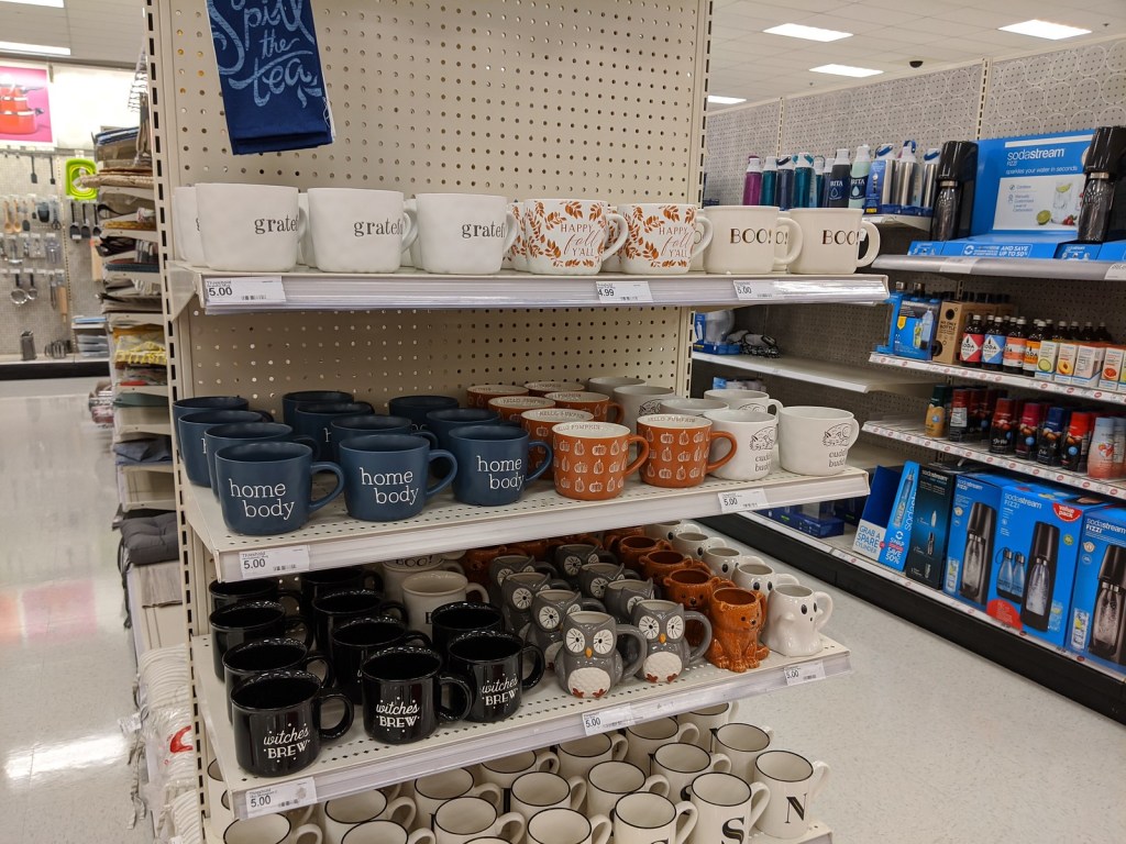 cute fall-themed mugs on store shelf