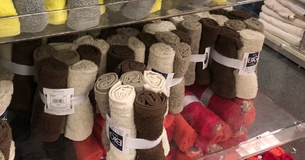 brown and cream colored washcloth sets sitting on a store shelf