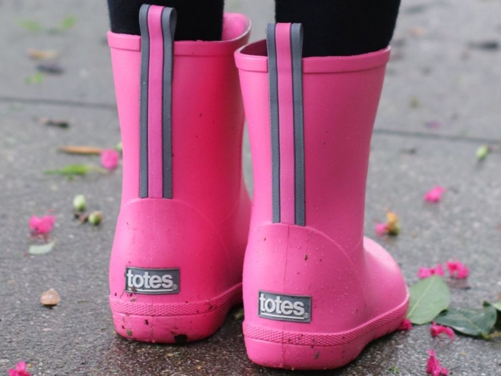 little girl wearing tall rain boots 