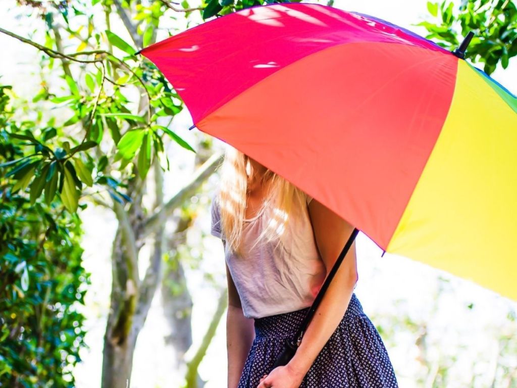 woman holding giant golf umbrella