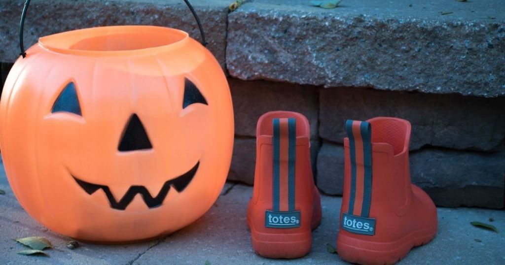 Totes Rain Boots for Kids next to orange pumpkin pail