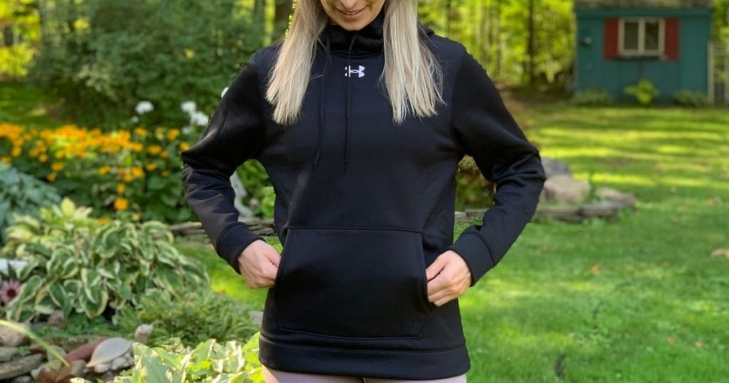 woman wearing under armour funnel neck hoodie with front pocket 