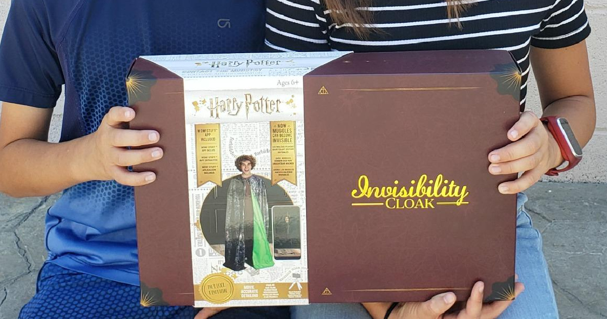 two children holding box with Harry Potter Invisibility Cloak