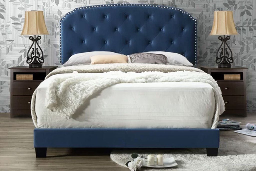 navy blue tuffed upholstered headboard with mattress and white bedding