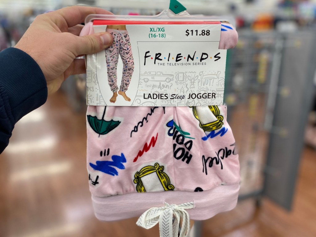 hand holding Friends themed joggers in-store
