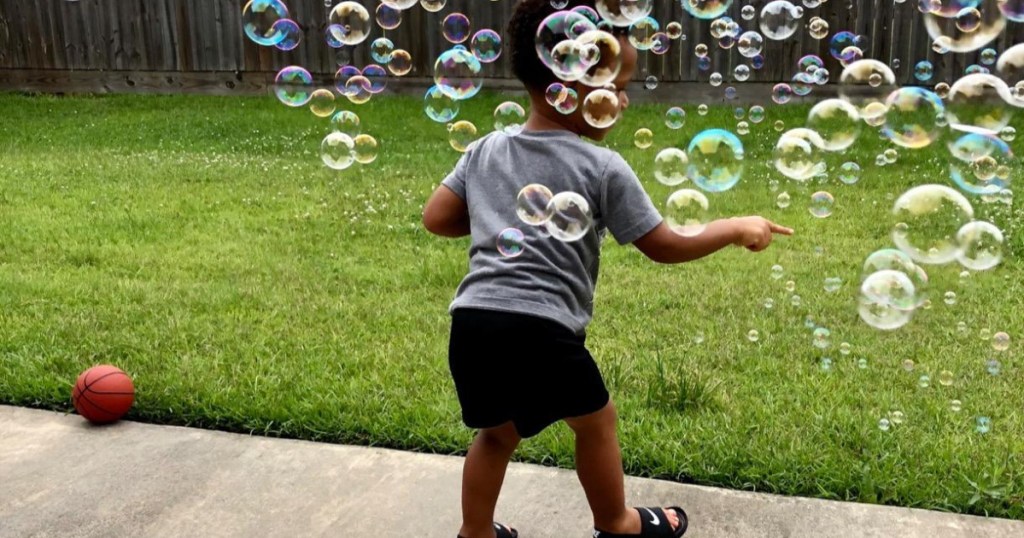boy with tons of bubbles in the air