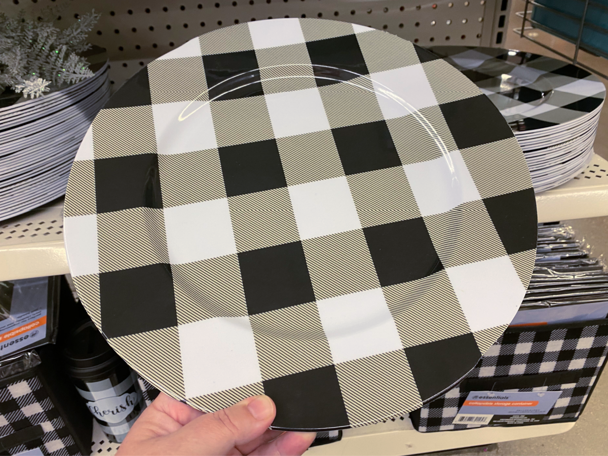 hand holding black and white plaid plate