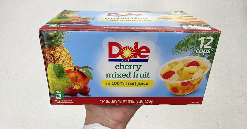 holding a 12-pack of Dole fruit bowls