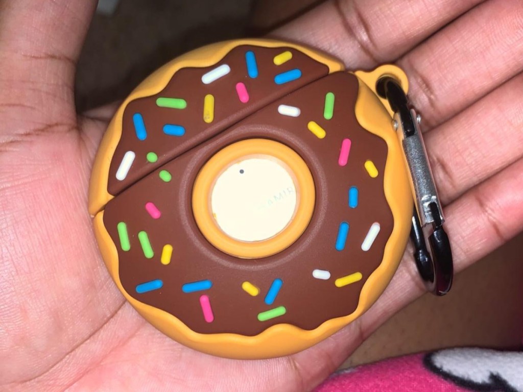 holding doughnut-shaped cute AirPods case