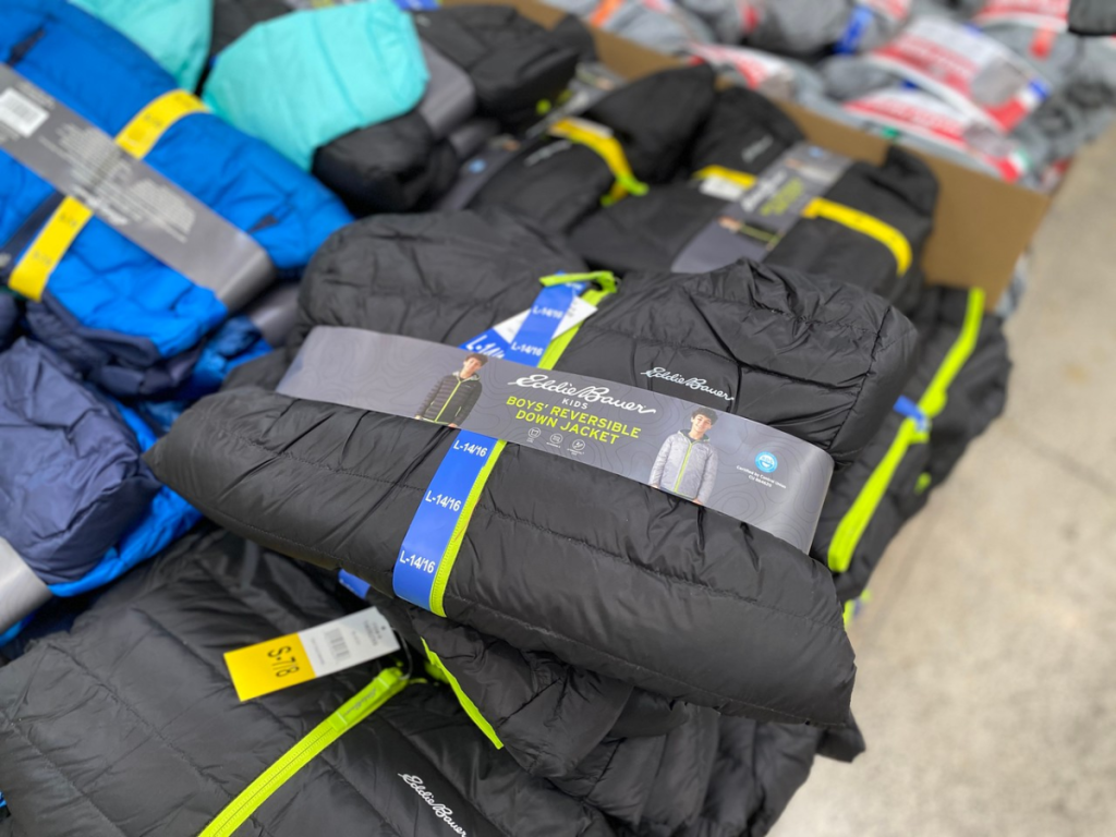 stack of kids winter jackets in a store