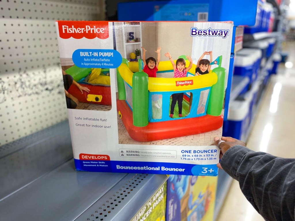 holding an inflatable bouncer in a box
