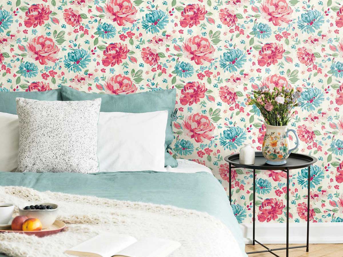 a bedroom with a floral wall of wallpaper