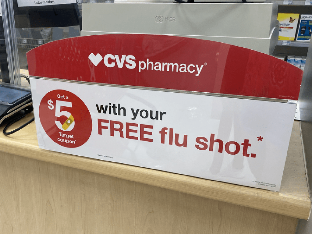 counter in pharmacy with sign about flu shot