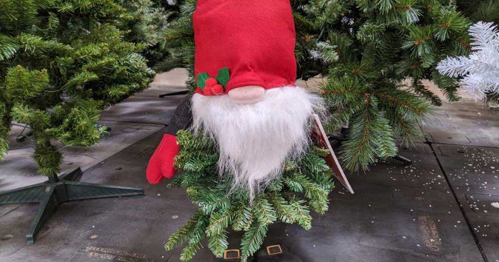 christmas gnome standing by trees