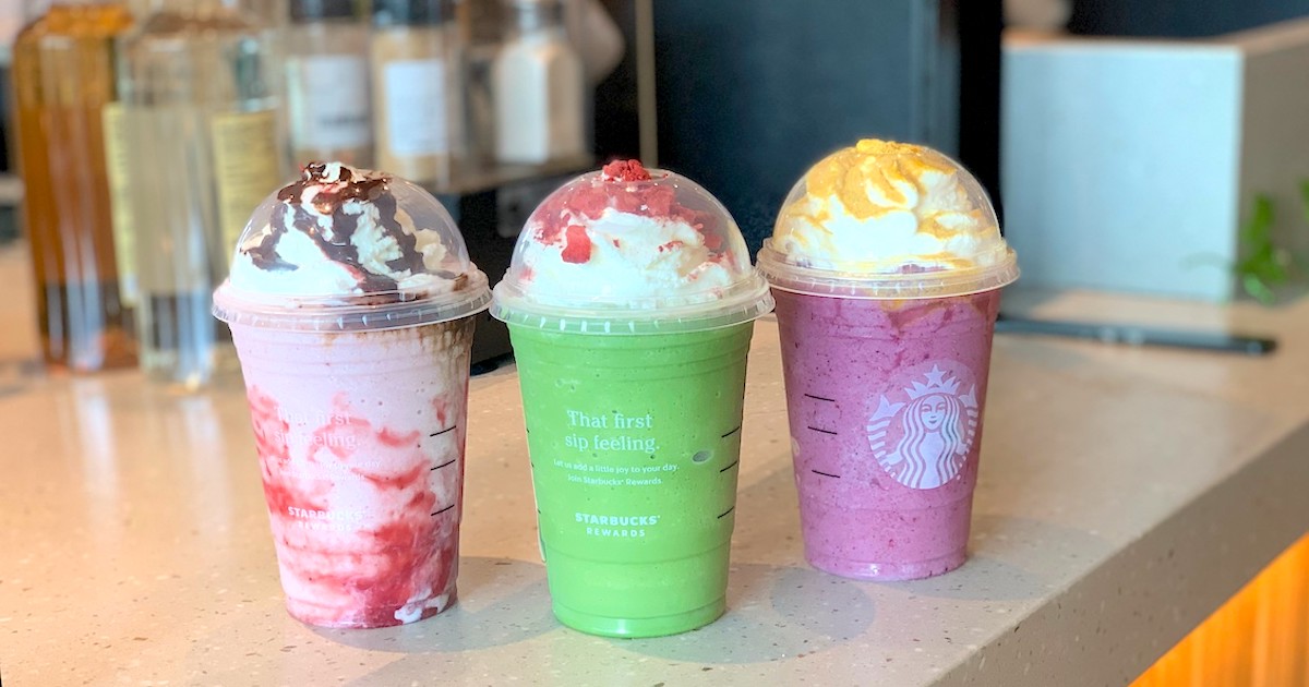 three colorful sanderson sisters frappuccinos on starbucks counter