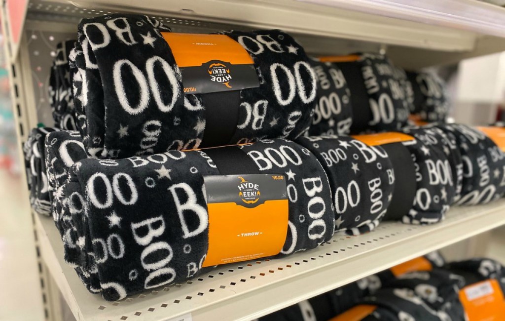 black throw blankets with white boo words on a store shelf