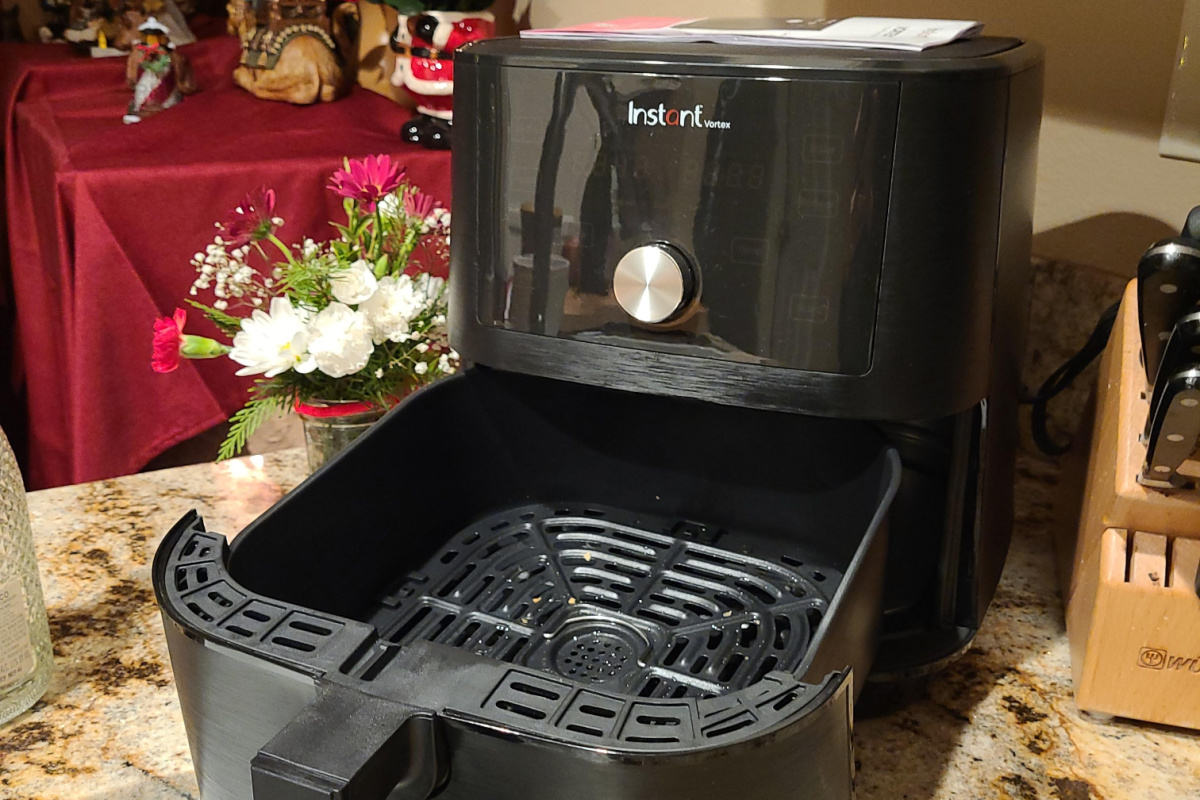 instant pot air fryer with open basket on counter 