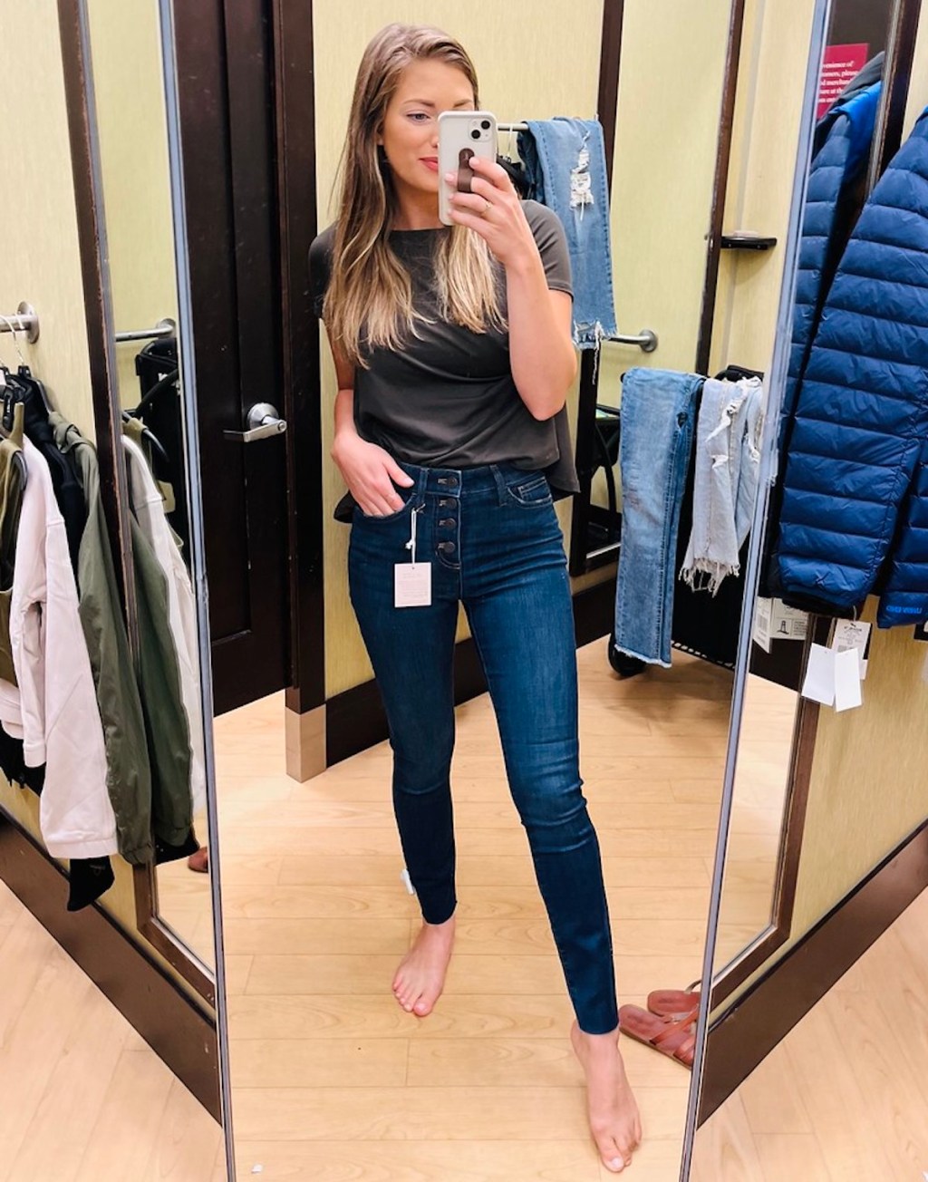 woman taking selfie in dressing room mirror