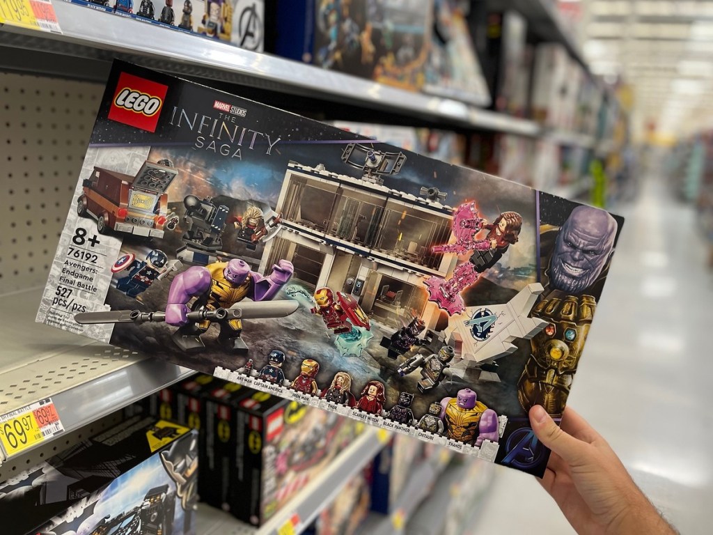 holding a LEGO Marvel Avengers set in the box