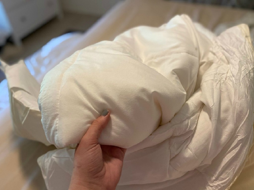 hand on a white comforter