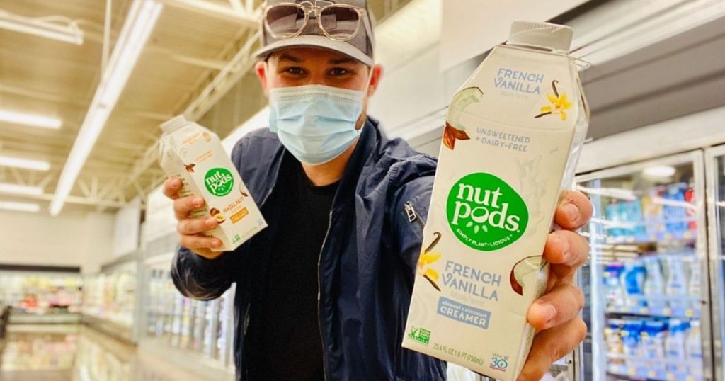 man wearing face mask holding nut pods