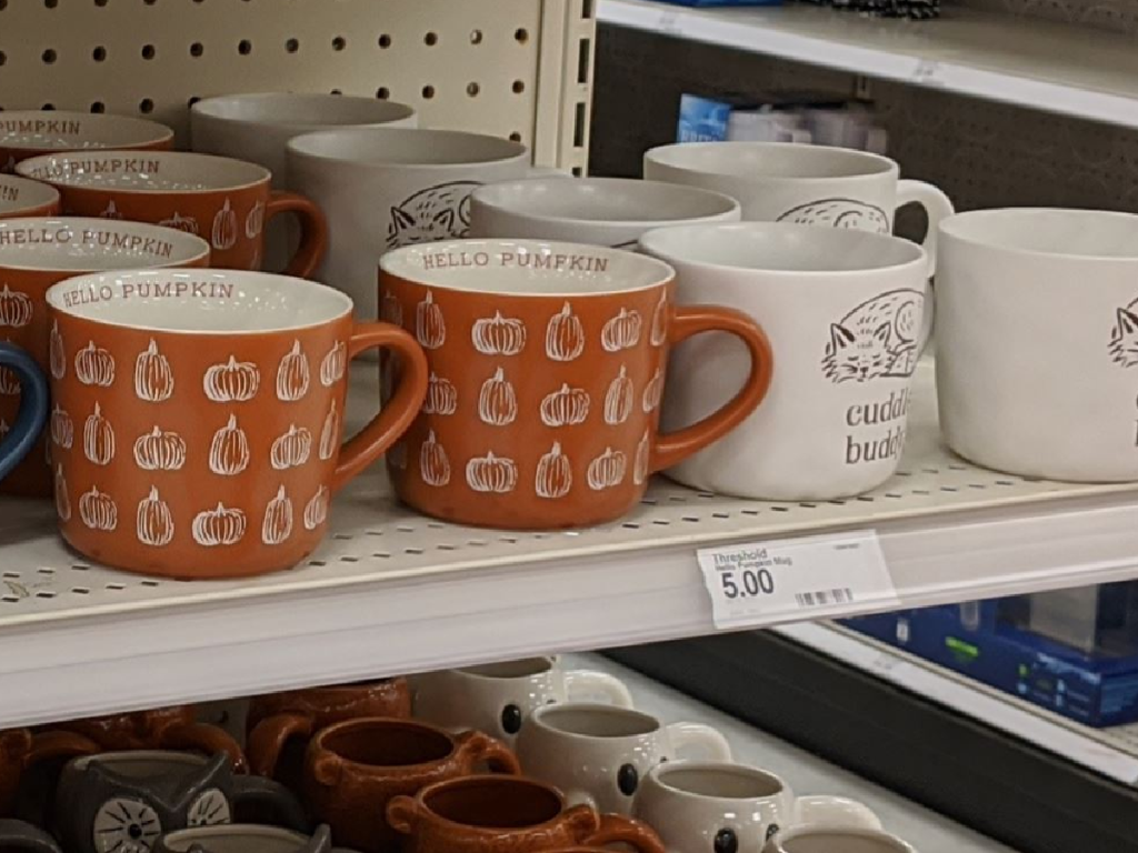 mugs on store shelf with fall themes