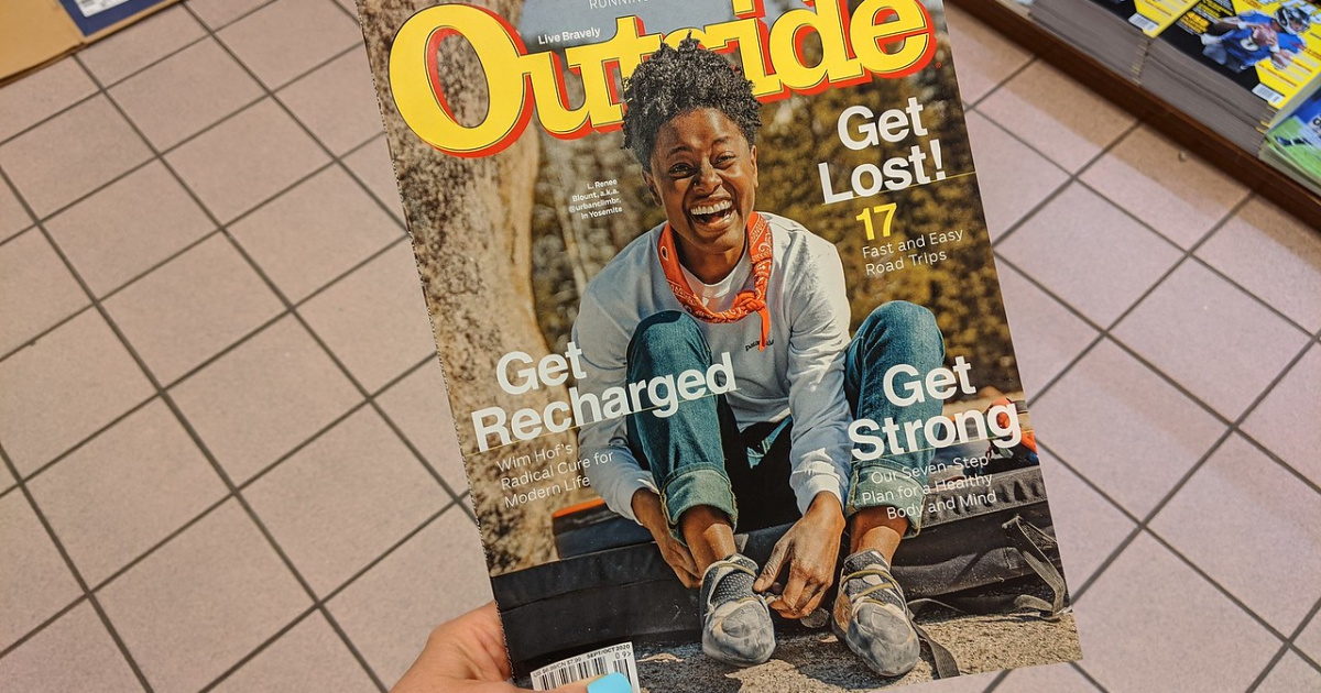 person holding Outside Magazine
