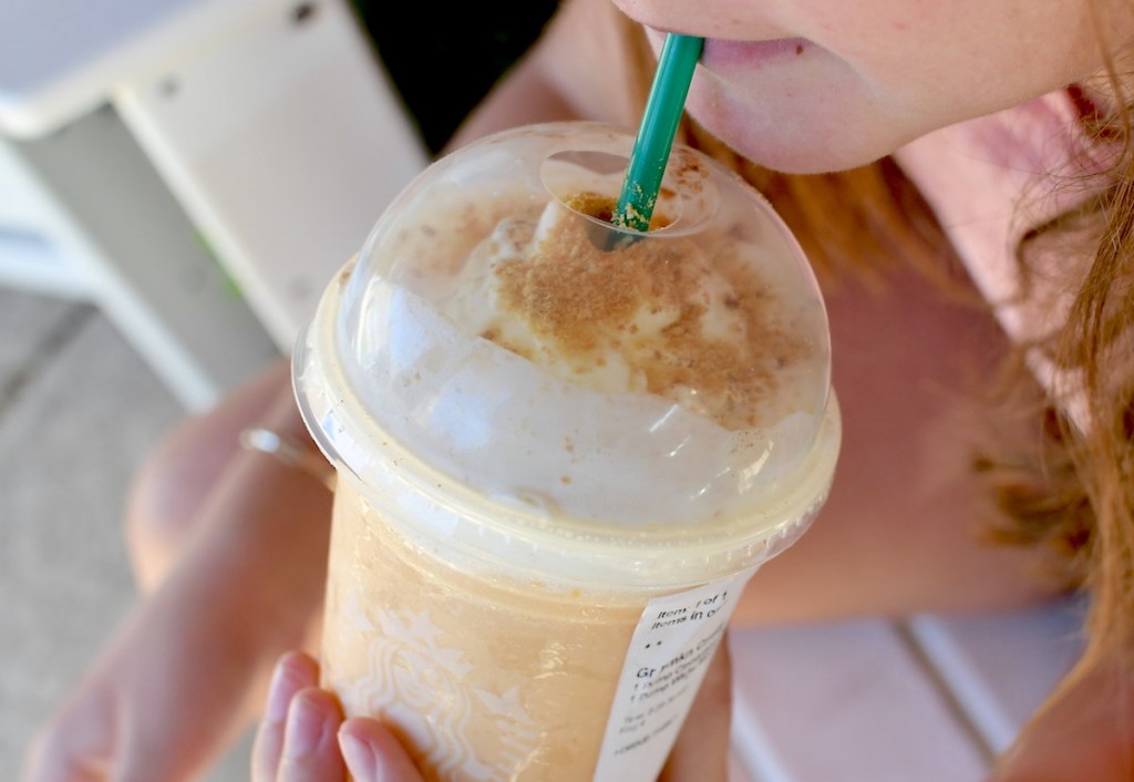 girl sipping on starbucks pumpkin frappuccino drink