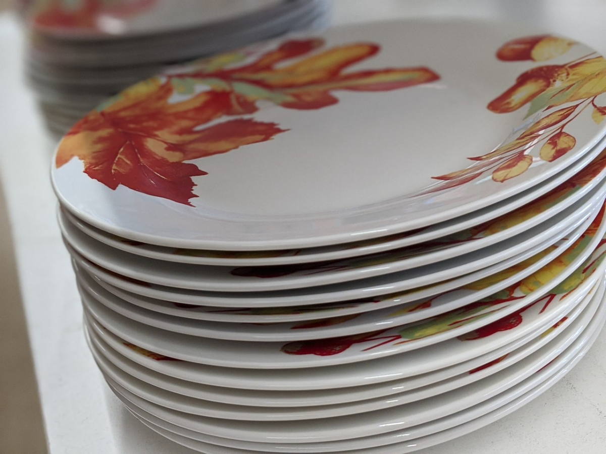 plates stacked up in store with leaves painted on them