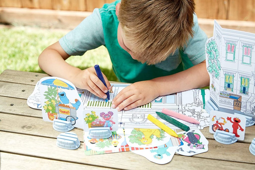 little boy with sesame street coloring set
