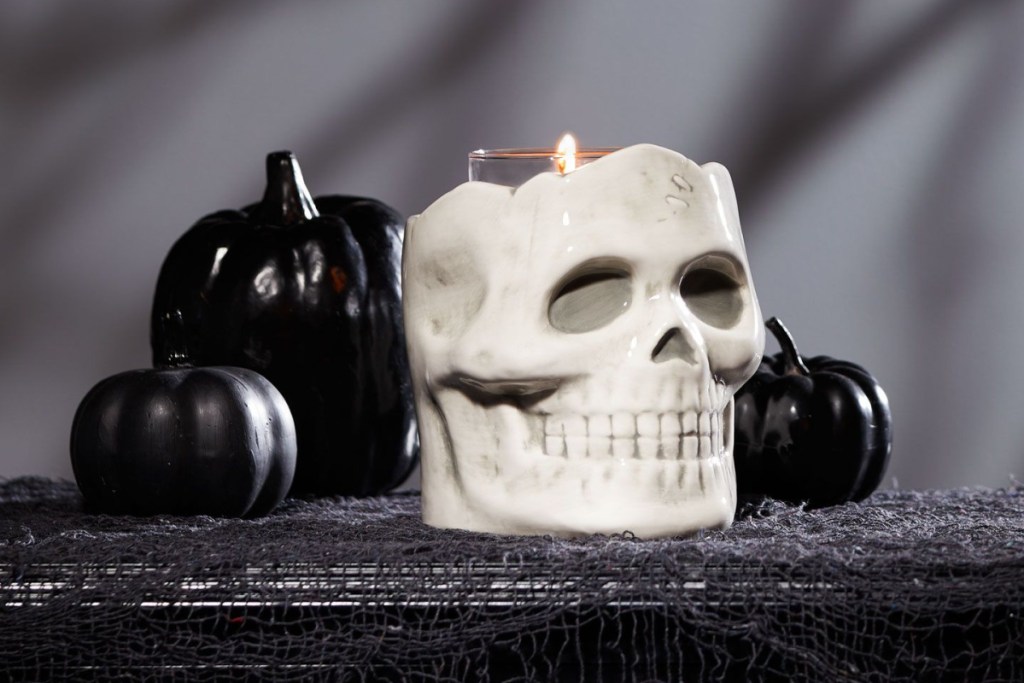 skull candle holder with black pumpkins
