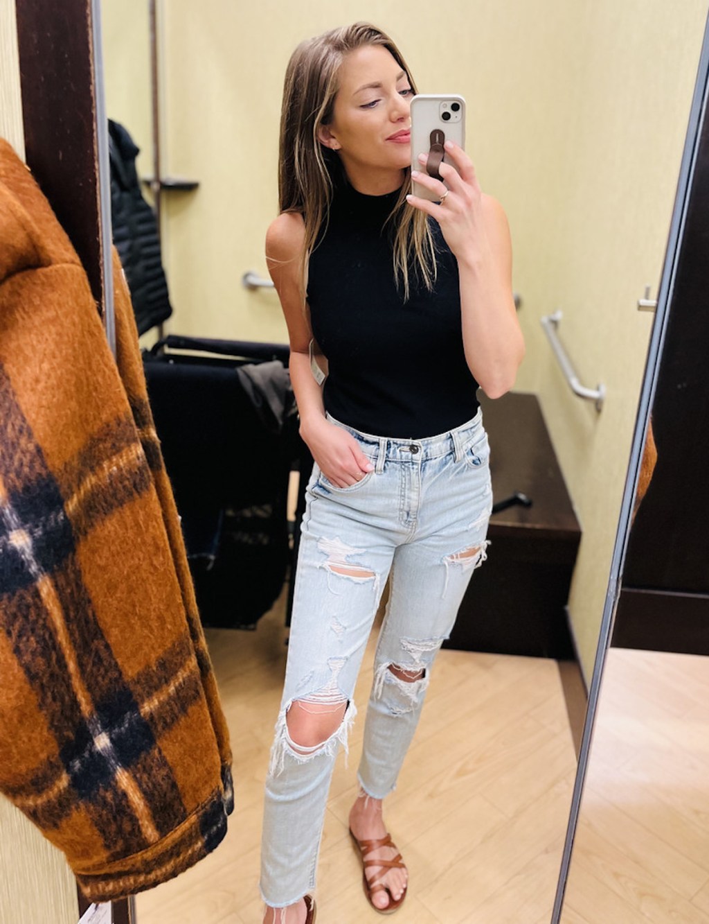 woman taking selfie in dressing room mirror