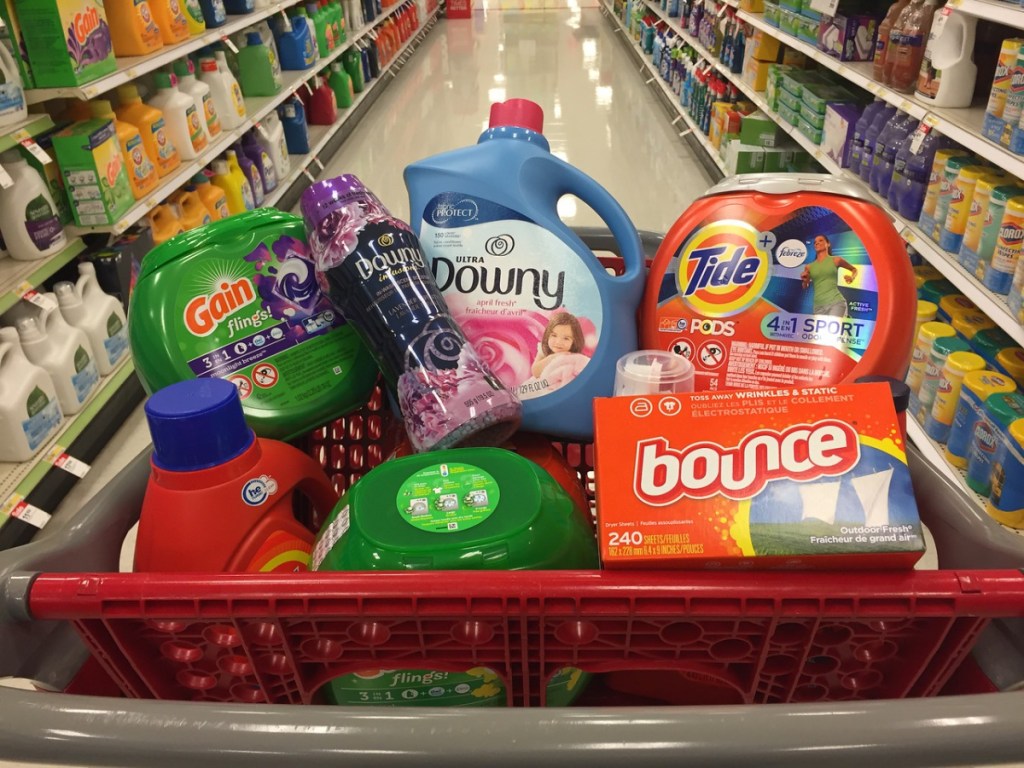 red grocery basket full of laundry products in a store