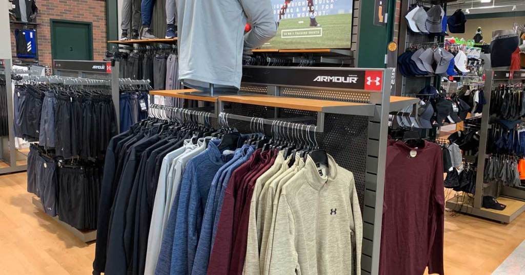 under armour pullover half-zip jackets on hangers on a store display