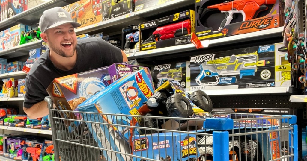 man pushing cart full of toys at Walmart