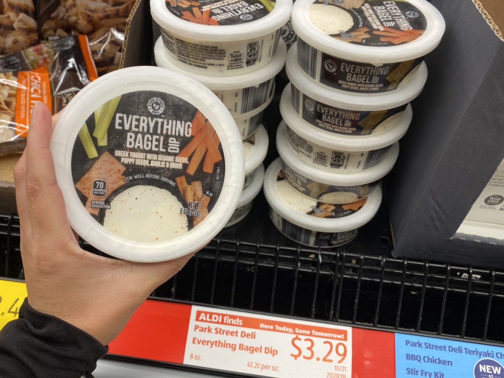 hand holding tub of everything bag dip in store