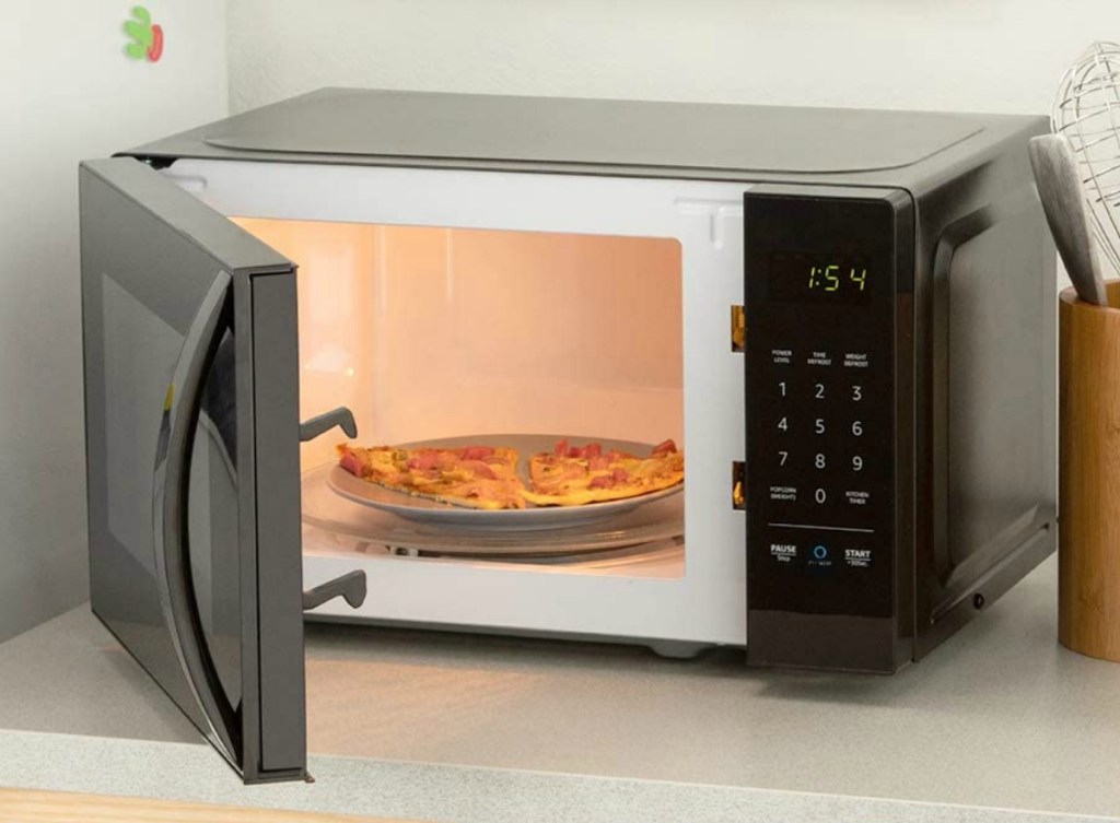 Small black microwave on a counter top with the door open
