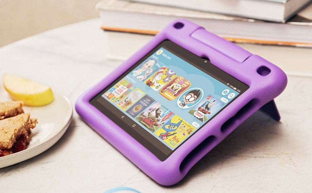 amazon fire kids tablet with purple case on a wood table