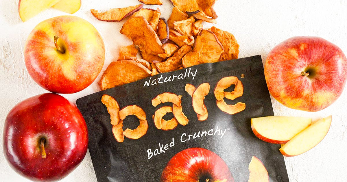 bag of bare baked apple chips with apple chips and red apples around it