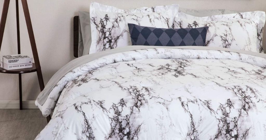 bed with a marble print comforter on it