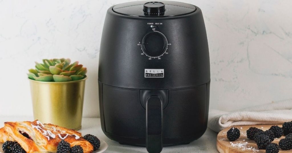 air fryer with food around it