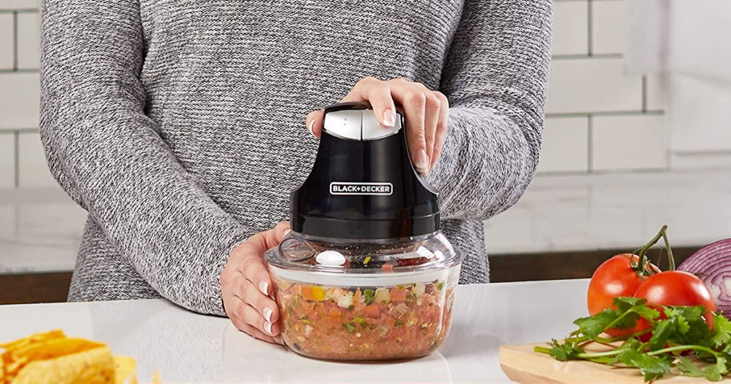 woman in grey sweater using a black and decker food chopper to make salsa