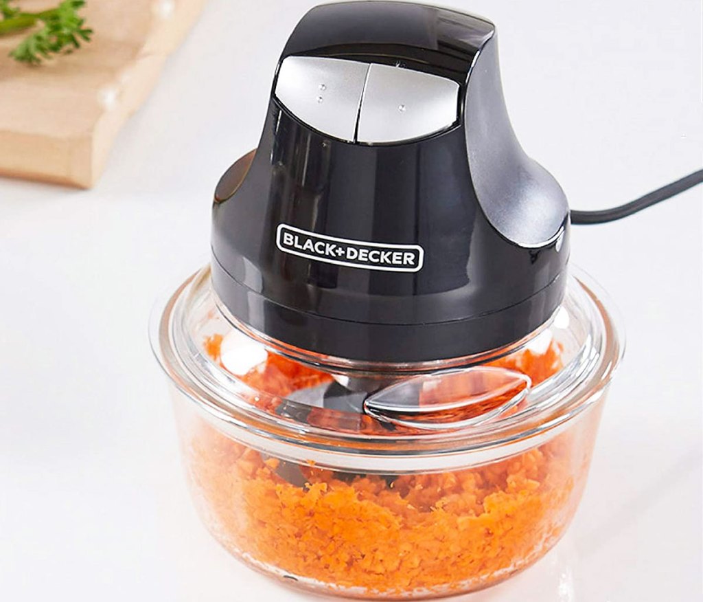 black and decker food chopper cutting up carrots in a glass bowl